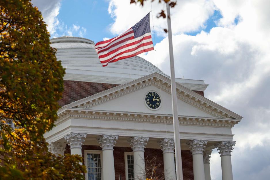 front entrance of the UVA Rotunda on an overcast afternoon with a flagpole in the foreground