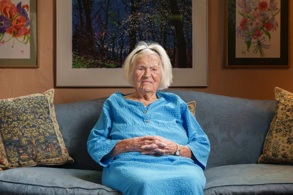 portrait of Virginia Stokes sitting on her couch in her living room