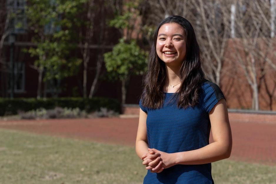 University of Virginia student Ailene Edwards wearing a blue dress and smiling