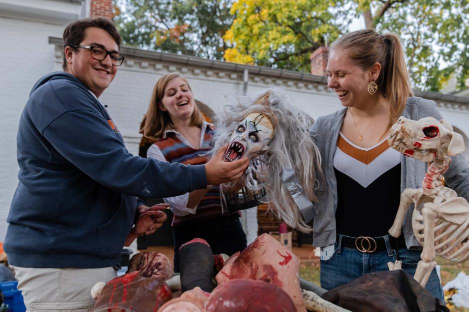 people gathered holding spooky props