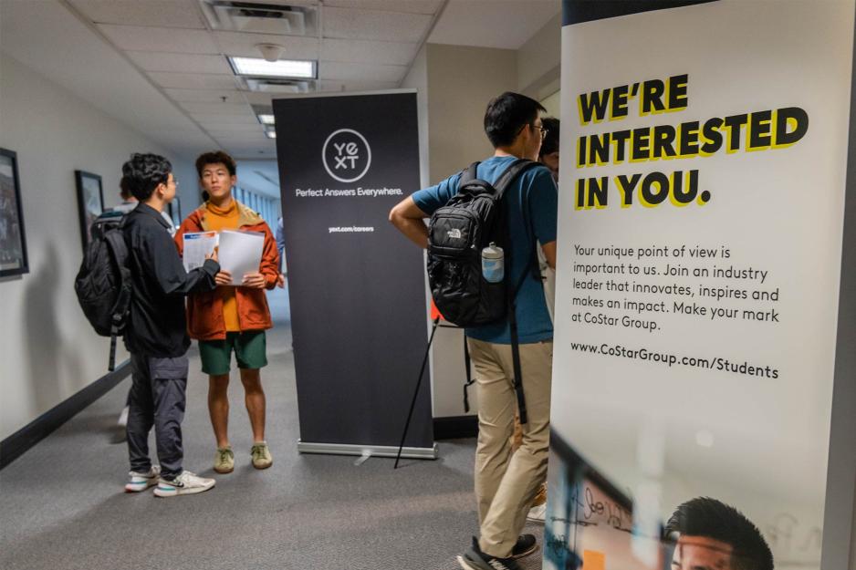 Students walking into the career center between floor to ceiling signs