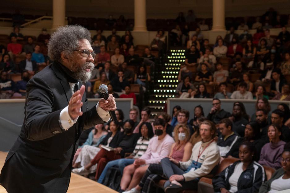 Cornel West on stage talking to a crowd