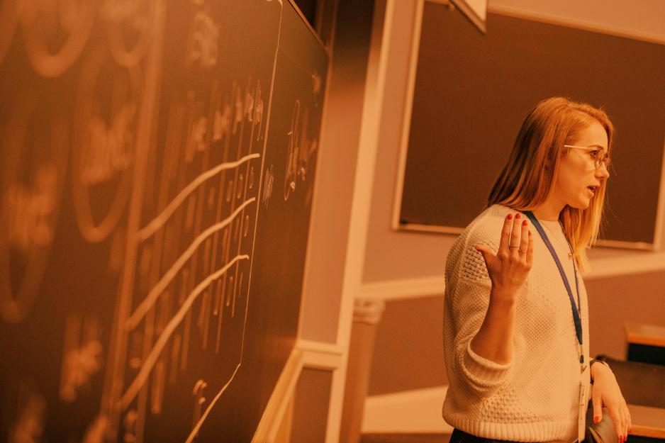 A female student presenting in a classroom.