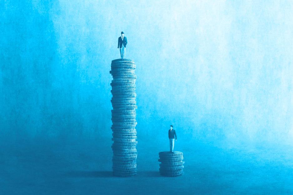 A man stands confidently on top of a tall stack of coins. A man standing on a shorter stack of coins looks up.
