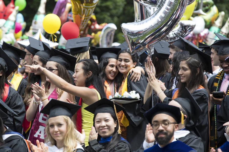 Graduating students walking the Lawn.