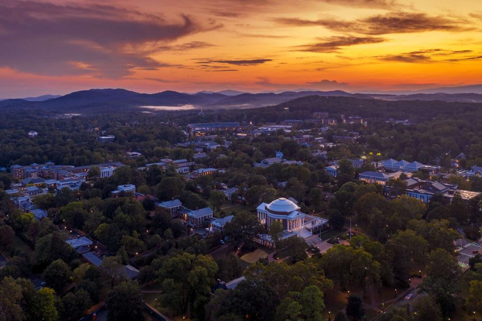 Aerial view of the Rotunda and surrounding area with storm clouds and a yellow sunset behind it