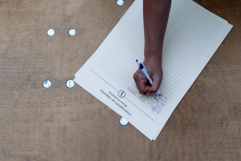 A University of Virginia student signs the Honor Pledge.