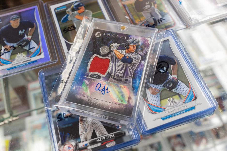 A small stack of baseball cards in sealed plastic cases