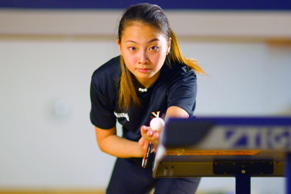 Portrait of Jie Lu about to serve in table tennis