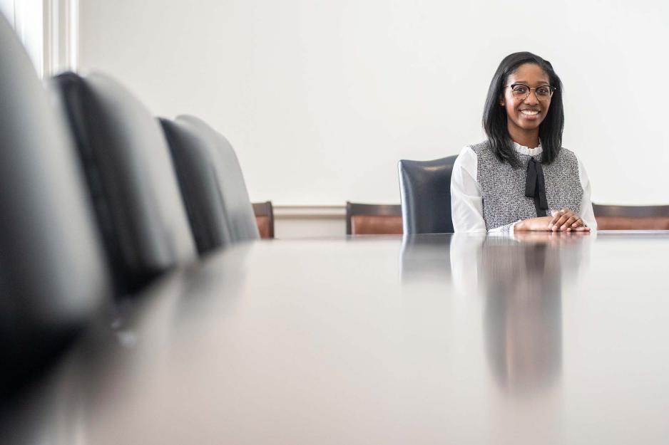 University of Virginia student and Board of Visitors member Lily Roberts sits at the end of a conference table.