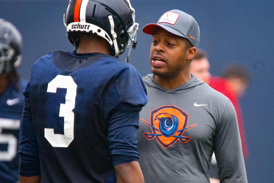 Marques Hagans talking to Virginia player number 3 during a game