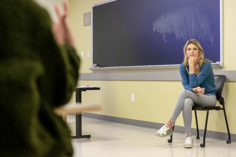 Woman sitting in chair listening to someone talking