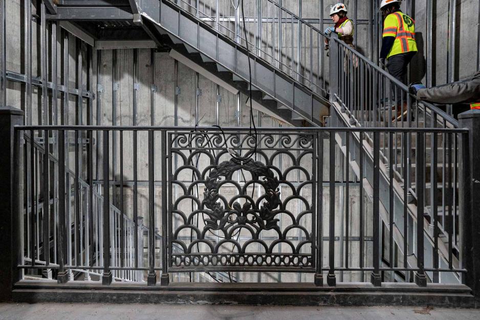 Image of construction working going up the stairs 