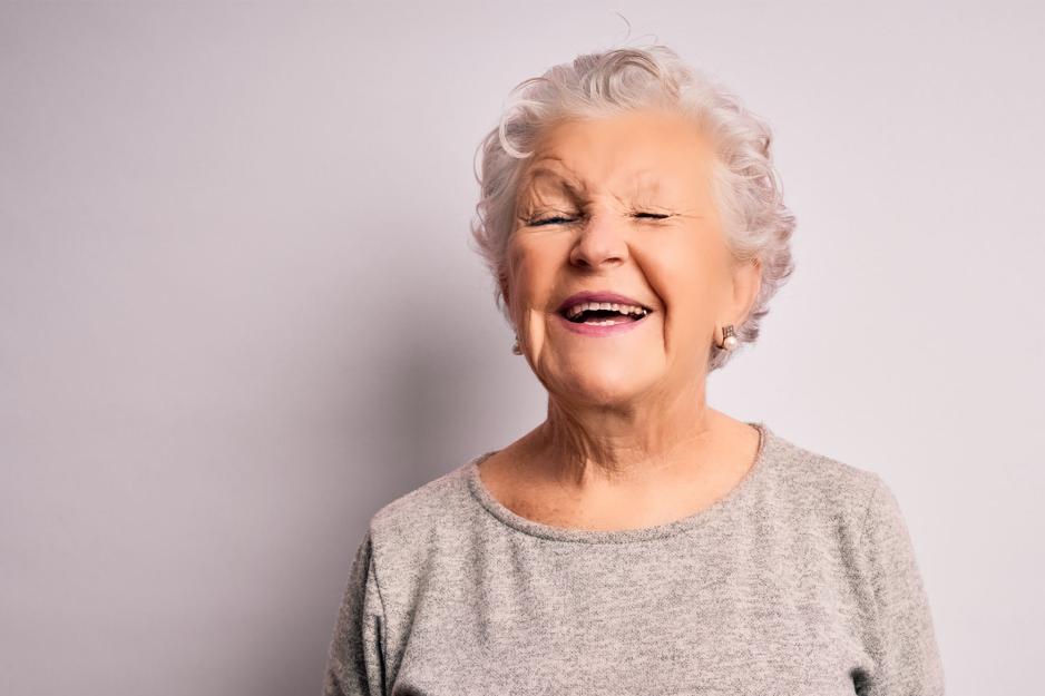 An elderly lady laughing