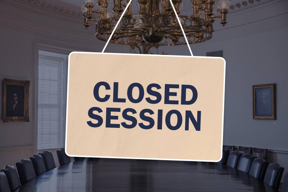 closed session sign in front of meeting room