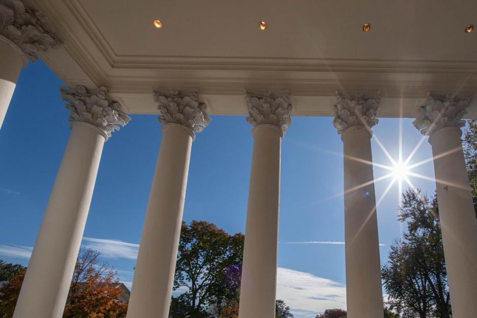 Looking up towards the sun through the columns of the Rotunda