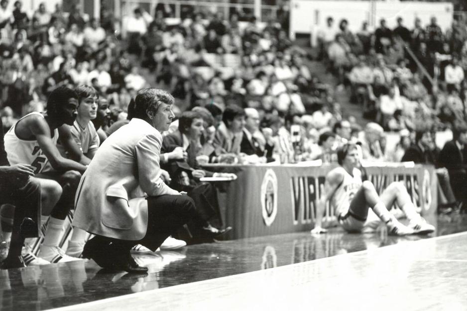 Terry Holland knelt down on the court watching the Cavaliers 
