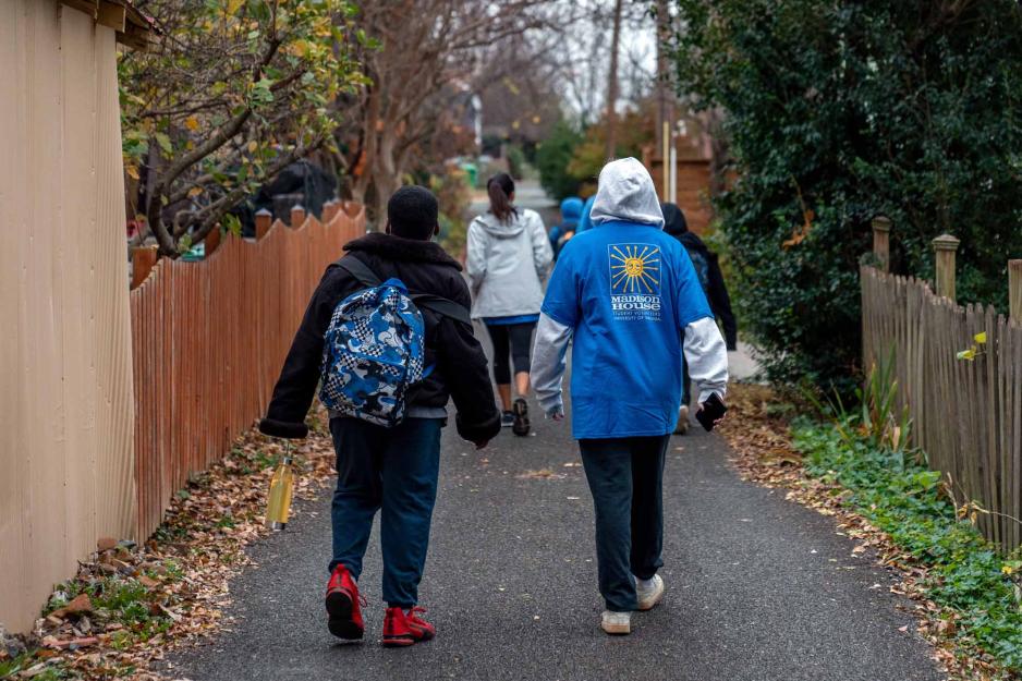 Students walking on a paved sidewalk together
