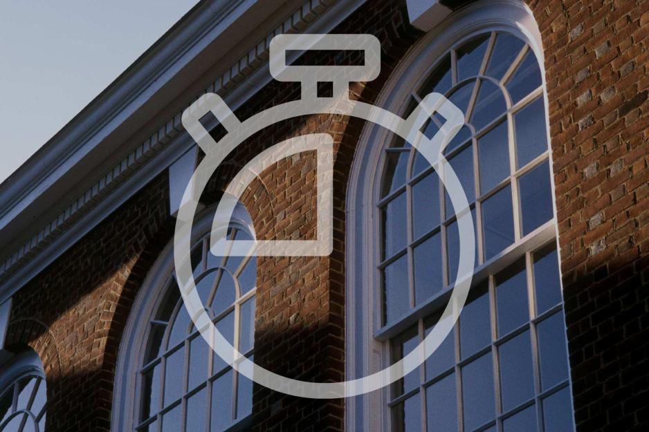 Clock icon overlayed on a building window