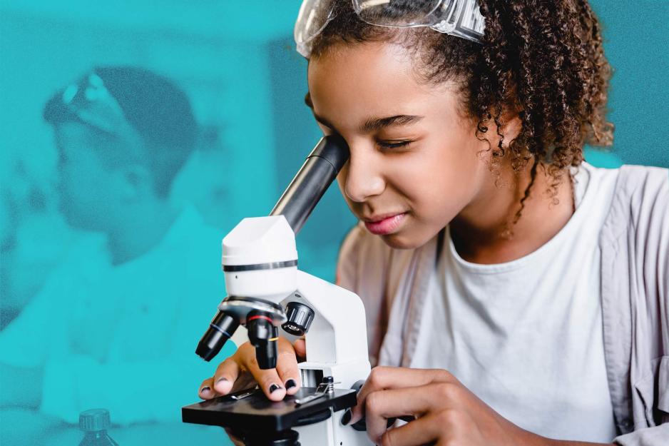 A child gazes through a microscope 