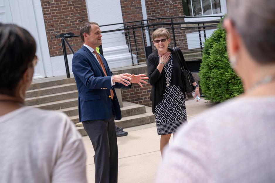 Pam Higgins looks pleasantly surprised while Jim Ryan talks and gestures to a crowd