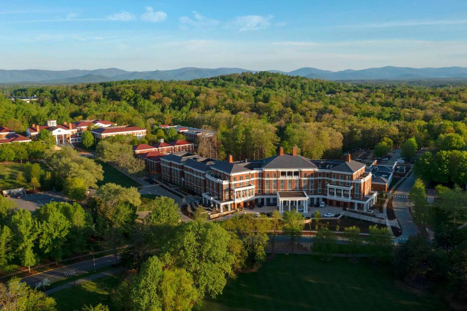 An aerial shot of The Forum Hotel with mountain ridges in the background