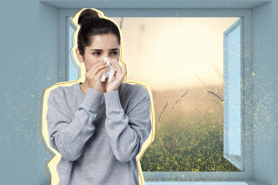 Woman blows nose while pollen spills into her house through an open window