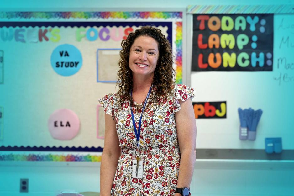 Portrait of Anne Duckworth standing in her classroom.