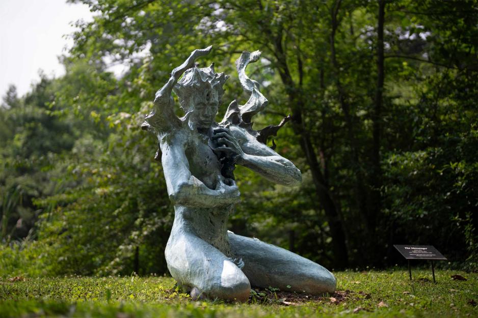 Sculpture sitting in a green nature section