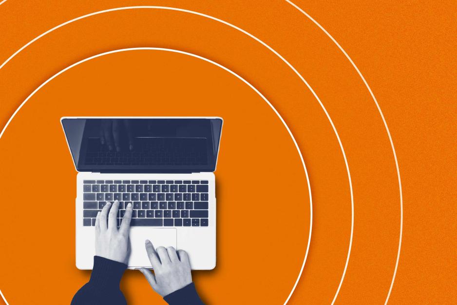 Illustration looking down at hands typing on a Mac laptop