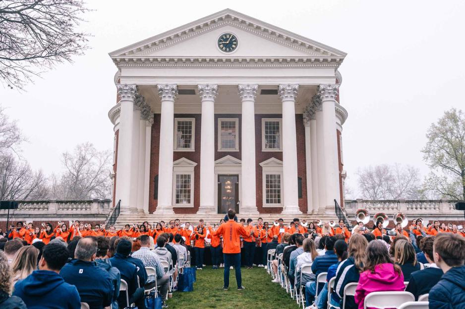 Rotunda with prospective students seated in front of UVA marching band