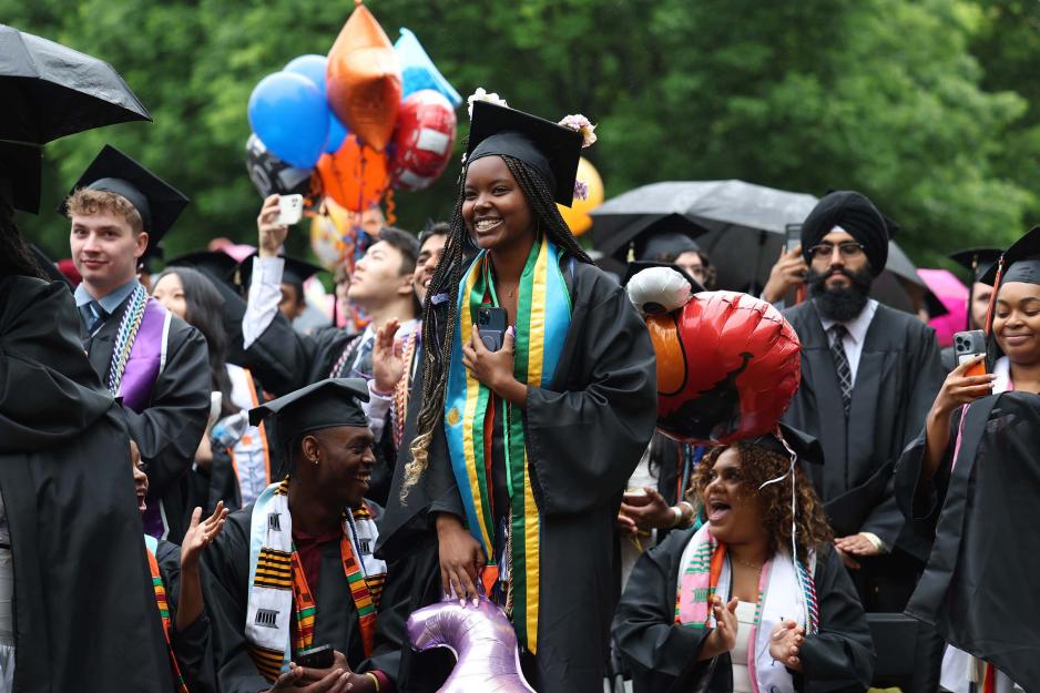 Happy graduating students processing down the Lawn