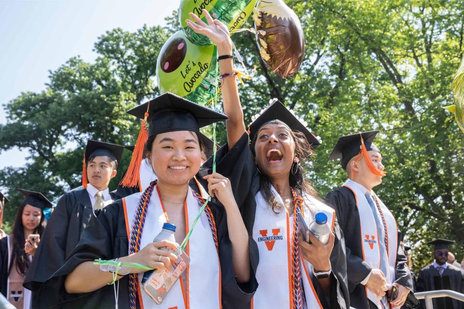Excited students celebrate as they walk the Lawn