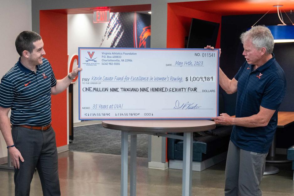 Rowing coach Kevin Sauer receiving a check 