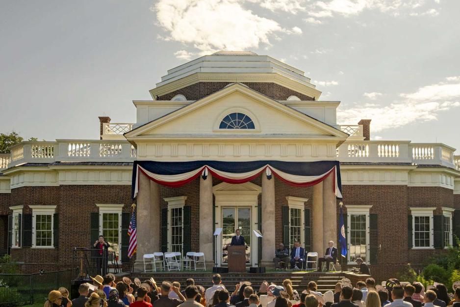 President Ryan on a stage in front of Monticello addressing the audience.