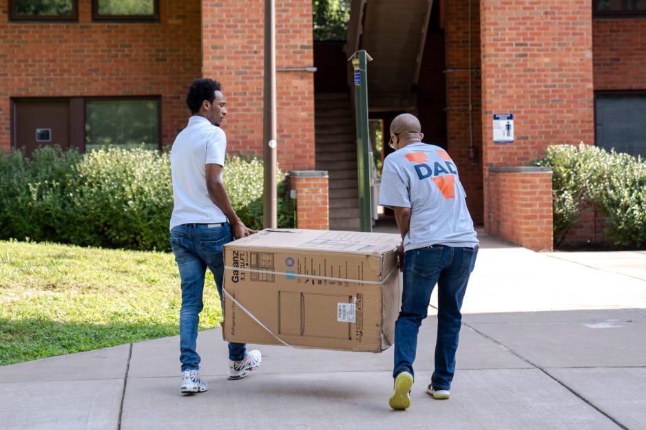 Dad and student unload a fridge