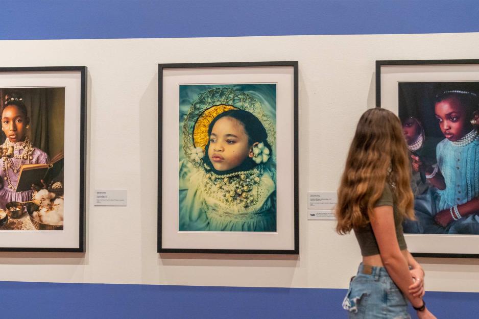 Student looking at art hanging in a gallery