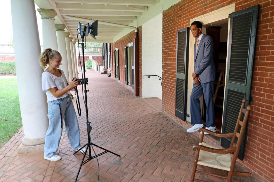 UVA Today photographer, Emily Faith Morgan photographs Ralph Sampson in the doorway of his old Lawn room
