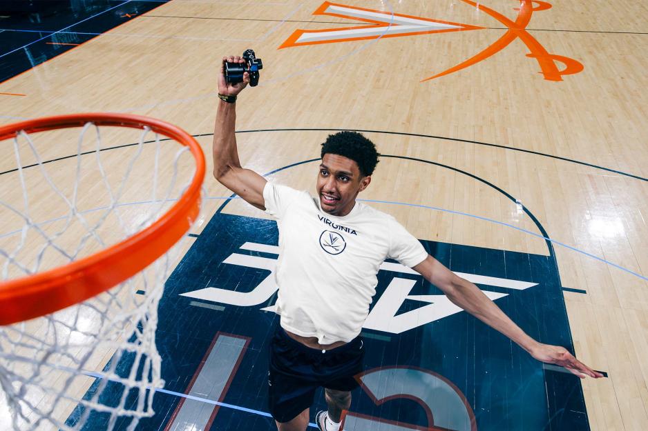 Dunn dunking camera into basketball hoop