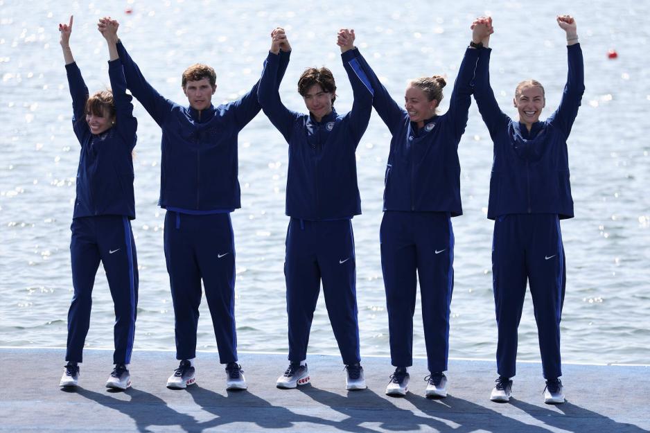 A group portrait of the US Paralympics rowing team celebrating their silver medal win, including UVA student rower Skylar Dahl on the far right.