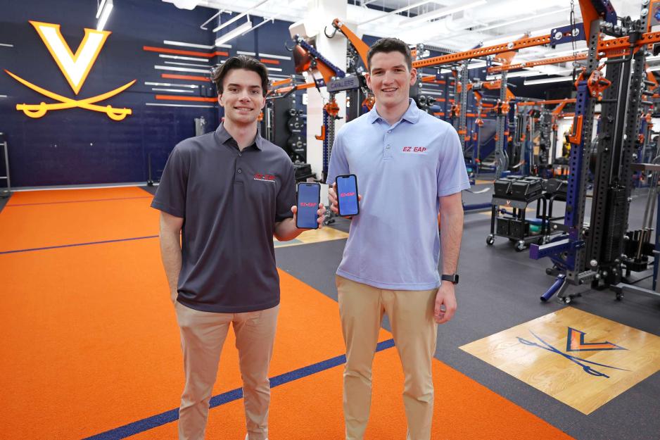 A.J. Peppers, left, and Nursing School student Jacob Swisher pose with their app in a UVA gym