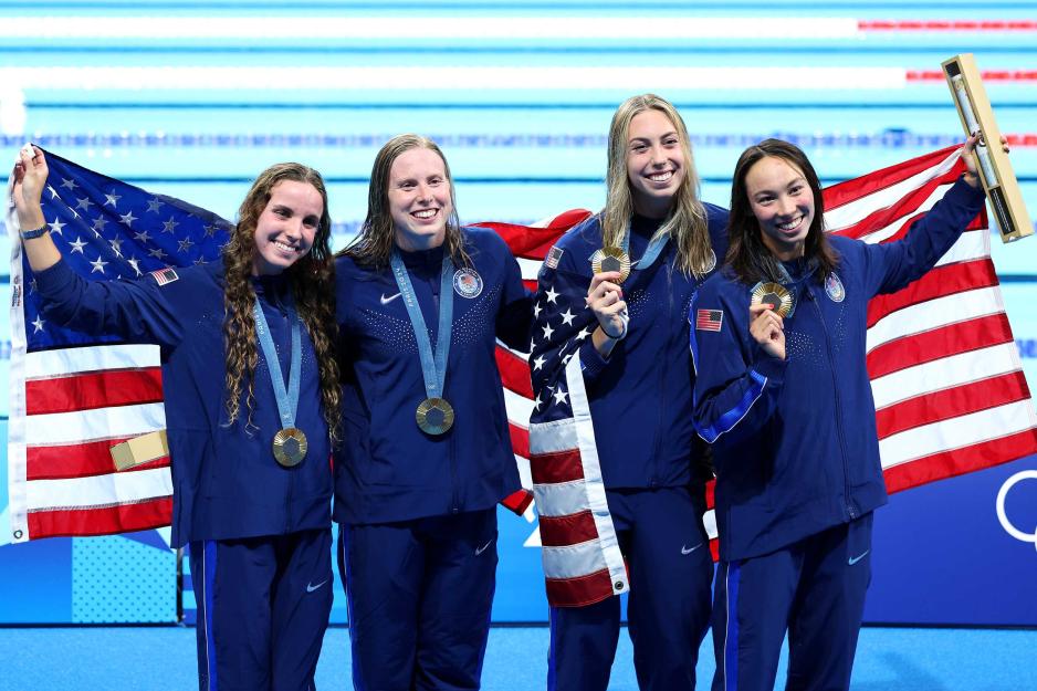 UVA student-athlete Gretchen Walsh, second from right, poses with her gold medal Sunday along with U.S. swimming teammates Reagan Smith, Lilly King and Torri Huske. It was Walsh’s second gold of the Games. 