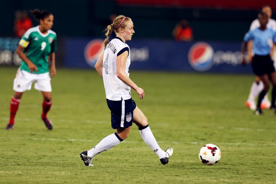 Becky Sauerbrunn kicks a soccer ball during a game