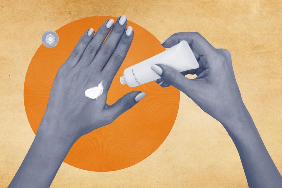 A hand squeezes sunscreen from a tube onto another hand