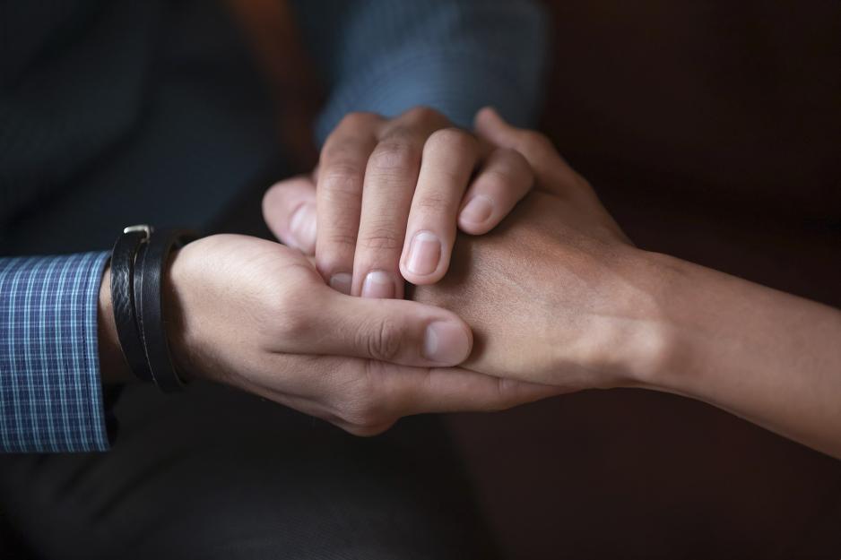 Two people holding hands