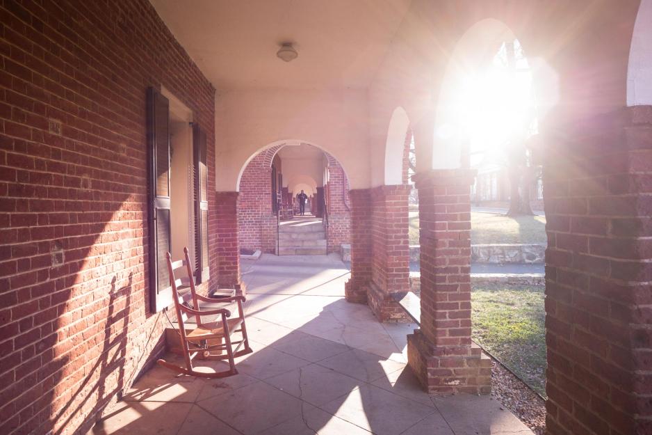 The Lawn covered sidewalks with rocking chair next to a Lawn Room