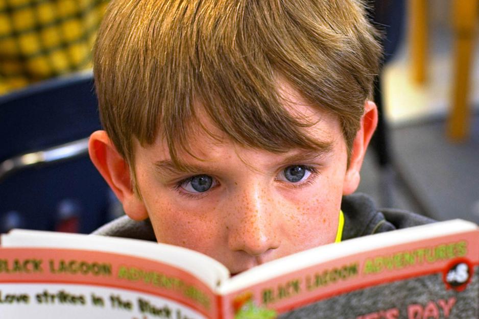 Close up of a child reading a book