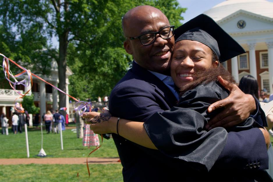 Happy grad hugs her dad in celebration 