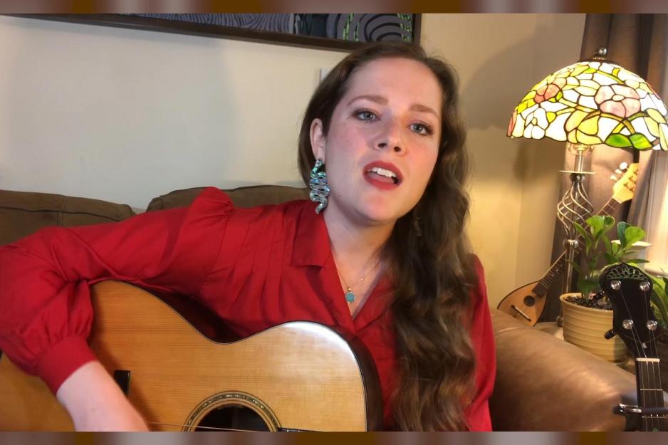 Woman playing guitar and singing