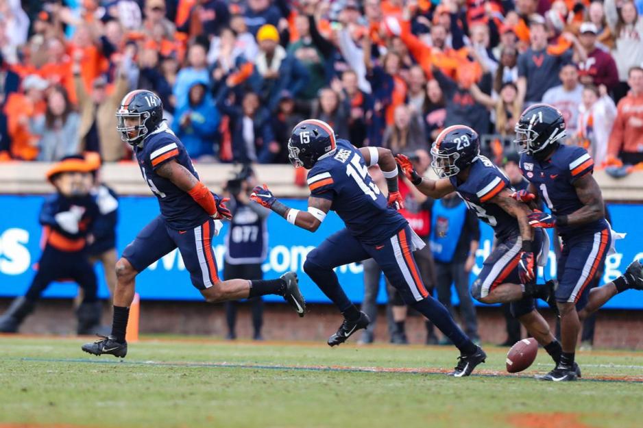 Cavaliers running down the field in celebration of victory